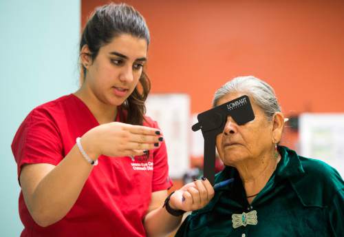 Rick Egan  |  The Salt Lake Tribune

Volunteer technician, Nora Alnajjarat  assists Lucy Cly, as she takes an eye test, at the Monument Valley Community Health Center, Friday, September 25, 2015.