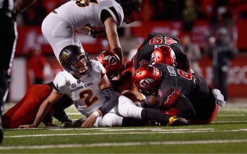 Scott Sommerdorf   |  The Salt Lake Tribune
The Utah defense recovers a fumble by Arizona State Sun Devils QB Mike Bercovici (2) that led to the clinching FG by Utah Utes PK Andy Phillips (39) and a 27-18 lead. Utah defeated Arizona State 34-18, Saturday, October 17, 2015.