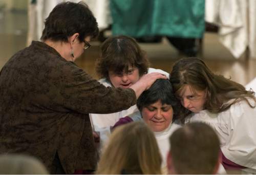 Steve Griffin  |  The Salt Lake Tribune

Friends, supporters and family members lay their hands on Clare Julian Carbone at the First United Methodist Church in Salt Lake City during her ordination to the priesthood by a group called Association of Roman Catholic Women Priests Sunday, October 18, 2015.  The Catholic Church does not recognize such ordinations, but the women priest movement  has ordained 220 women since beginning in Germany in 2002.