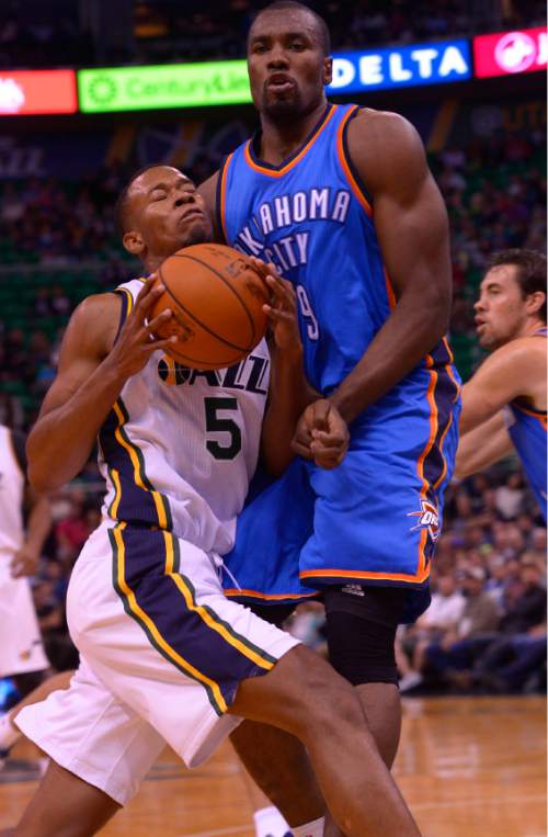 Leah Hogsten  |  The Salt Lake Tribune
Utah Jazz guard Rodney Hood (5) draws the foul on Oklahoma City Thunder forward Serge Ibaka (9). Oklahoma City Thunder lead the Utah Jazz  57-43 at the half, Tuesday, October 20, 2015 at Energy Solutions Arena.