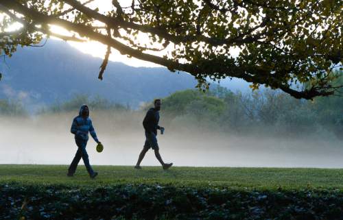 Francisco Kjolseth | The Salt Lake Tribune
The mist rises at Creekside Park in Holladay as Bryce Arnett, left, and Blake Child play an early round of disc golf on Tuesday, Oct. 20, 2015.