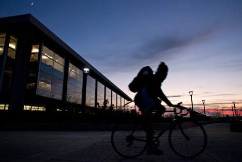 Lennie Mahler  |  The Salt Lake Tribune
A cyclist passes by the Marriott Library on the University of Utah campus at sunset Tuesday, Nov. 29, 2011.