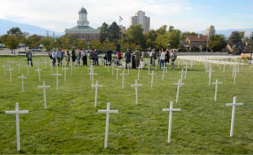 Al Hartmann  |  The Salt Lake Tribune
361 crosses were placed on the front lawn of the Utah State Capitol Thursday Oct. 21 for Alliance for a Better Utah to make a visual point for their press conference.  Today marks 657 days since the Utah Legislature had the first opportunity to grant access to affordable healthcare for thousands of Utahns most in need. Better Utah estimates that as many as 361 Utahns (represented by the rows of crosses) have died because they don't have access to affordable healthcare.