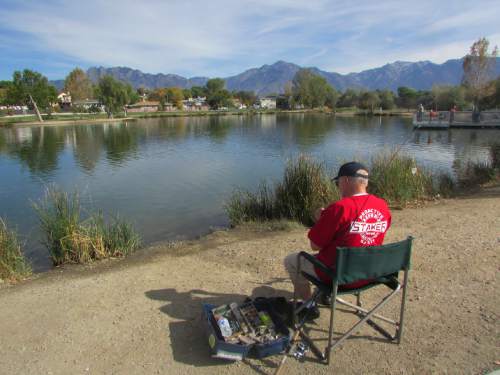 Tom Wharton  |  The Salt Lake Tribune

Kelly Johnson enjoys an afternoon fishing at Murray's Willow Pond.