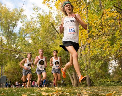 Rick Egan  |  The Salt Lake Tribune

Adam Jensen Lone Peak, runs though the fall leaves, in the cross country state championship race at Sugarhouse Park, Wednesday, October 21, 2015.