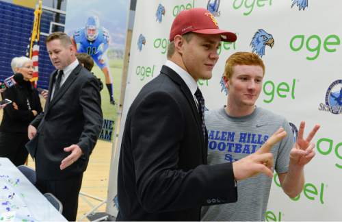 Francisco Kjolseth  |  The Salt Lake Tribune 
Salem Hills quarterback/linebacker Porter Gustin, one of the most highly touted prep football prospects in recent memory, poses for a photograph with teammate Neil Davis following his announcement that he plans to attend USC during a school assembly on Tuesday, Feb. 3, 2015.