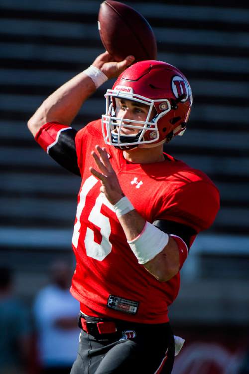 FILE - In this Friday April 3, 2015 file photo, Utah quarterback Chase Hansen (15) passes the ball during a practice at Rice-Eccles Stadium in Salt Lake City. Freshman Chase Hansen is the quarterback of the future for No. 3 Utah, but in the meanwhile, he's switched jerseys and sides of the ball.  (Chris Detrick/The Salt Lake Tribune via AP) DESERET NEWS OUT; LOCAL TELEVISION OUT; MAGS OUT; MANDATORY CREDIT