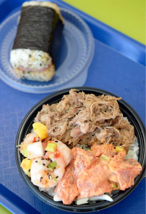 Al Hartmann  |  The Salt Lake Tribune
Poke bowl of Sweet Chili Shrimp with mango, Spicy Ahi Tuna, and Kalua Pig at the Laid Back Poke Shack at 6213 E. Highland Drive in Holladay. At top is "Musubi," a seaweed-wrapped rice roll with Spam.