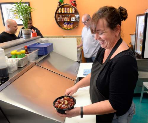 Al Hartmann  |  The Salt Lake Tribune
Lunch customers line up to order at counter from owners Deanna and Jimmy Zouras at the Laid Back Poke Shack at 6213 E. Highland Drive in Holladay.
