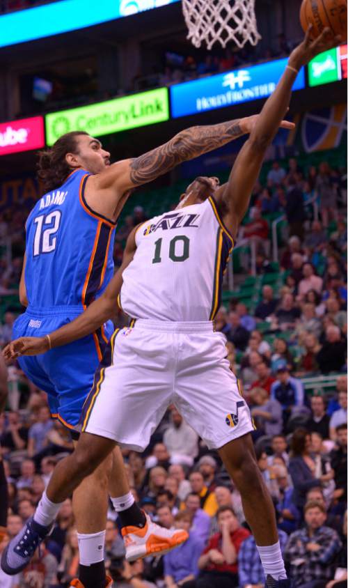 Leah Hogsten  |  The Salt Lake Tribune
Utah Jazz guard Alec Burks (10) shoots around Oklahoma City Thunder center Steven Adams (12).  Oklahoma City Thunder lead the Utah Jazz  57-43 at the half, Tuesday, October 20, 2015 at Energy Solutions Arena.