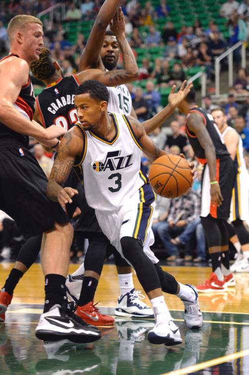 Steve Griffin  |  The Salt Lake Tribune

Utah Jazz guard Trey Burke (3) drives baseline as he tries to get past Portland Trail Blazers forward Mason Plumlee (24) during the Utah Jazz versus the Portland Trailblazers preseason NBA basketball game at EnergySolutions Arena in Salt Lake City, Monday, October 12, 2015.