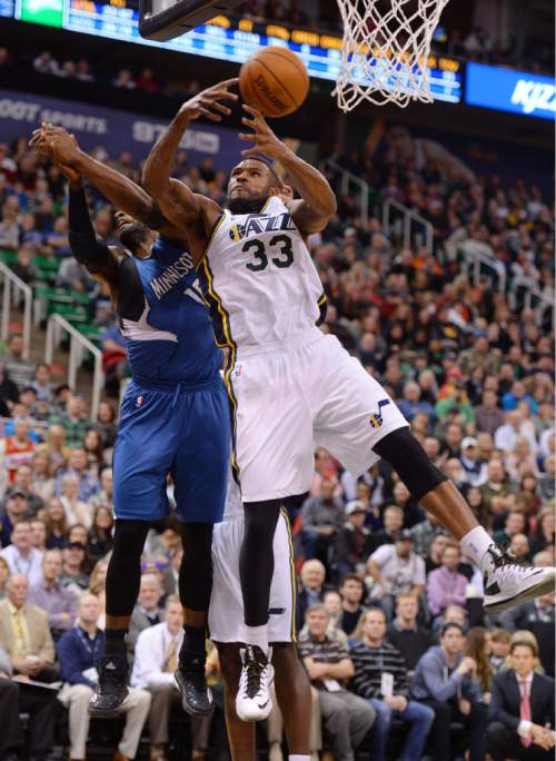 Steve Griffin  |  The Salt Lake Tribune

Utah Jazz forward Trevor Booker (33) grabs a rebound away from Minnesota Timberwolves forward Shabazz Muhammad (15) during second half action in the Utah Jazz versus  Minnesota Timberwolves NBA basketball game at EnergySolutions Arena in Salt Lake City, Tuesday, December 30, 2014.