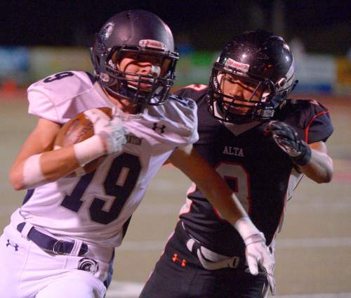 Leah Hogsten  |  The Salt Lake Tribune
Corner Canyon's wide receiver Kyle Reaveley is brought down by Alta's Trai Hunkin. 
Alta High School football team leads Corner Canyon High School 31-24, Friday, October 23, 2015 at Alta.