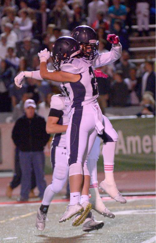 Leah Hogsten  |  The Salt Lake Tribune
Corner Canyon's Ryan Hanson celebrates his touchdown run with teammate Paul Bills. 
Alta High School football team leads Corner Canyon High School 31-24, Friday, October 23, 2015 at Alta.
