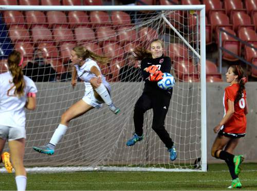 Scott Sommerdorf   |  The Salt Lake Tribune
Weber goalkeeper Hannah Johnson makes this save as Davis' Olivia Wade flashes by with a shot during second half play. Davis beat Weber 1-0 for the girl's 5A title at Rio Tinto stadium, Friday, October 23, 2015.