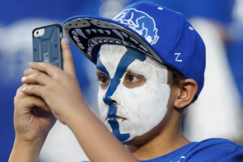 Trent Nelson  |  The Salt Lake Tribune
A young BYU fan photographs the team warming up pre-game as the BYU Cougars host the Utah Utes, college football Saturday, September 21, 2013 at LaVell Edwards Stadium in Provo.