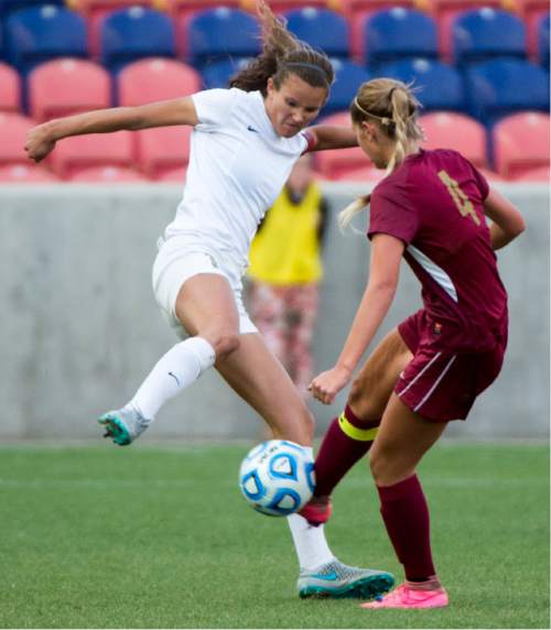Rick Egan  |  The Salt Lake Tribune

Cedar Redmen's Makenna Clark (4) goes for the ball, along with Logan Grizzlies Demi Lopez (10), in the 3A girls soccer state title game at Rio Tinto Stadium, Saturday, October 24, 2015.