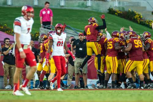 Chris Detrick  |  The Salt Lake Tribune
Utah Utes quarterback Travis Wilson (7) and Utah Utes wide receiver Tyrone Smith (81) walk off of the field as USC Trojans celebrate a interception touchdown by USC Trojans linebacker Cameron Smith (35) during the game at the Los Angeles Memorial Coliseum Saturday October 24, 2015.