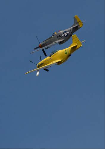 Francisco Kjolseth | The Salt Lake Tribune
Brig. Gen. Roland Wright, who piloted the "Mormon Mustang" in World War II, is laid to rest at Wasatch Lawn Memorial Park in Salt Lake City on Monday, Oct. 26, 2015. Three P-51s, including a replica of his plane, top, along with a Utah Air National Guard tanker aircraft fly over the cemetery in Wright's honor.
