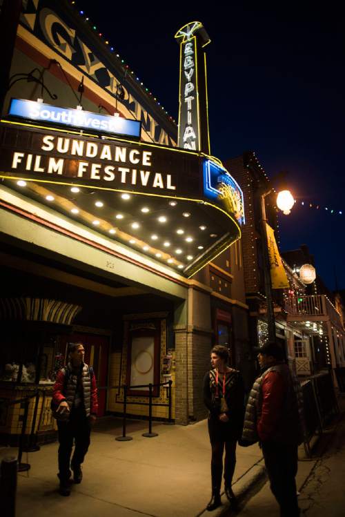 People talk outside of the Egyptian Theatre on Main Street during the first night of the 2015 Sundance Film Festival on Thursday, Jan. 22, 2015, in Park City, Utah. (Photo by Arthur Mola/Invision/AP)