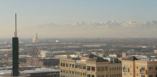 Al Hartmann  |  The Salt Lake Tribune
View from the Gateway looking southwest to the Oquirrh Mountains across the valley.    Air pollution, (pm 2.5) begins building up in downtown Salt Lake City Tuesday Jan. 6.  It looks worse than it is.  The Utah Department of Environmental Quality's measurement was about 20  for pm 2.5, putting it into the yellow mandatory action range.  Stay tuned for more of the same for the next few days.