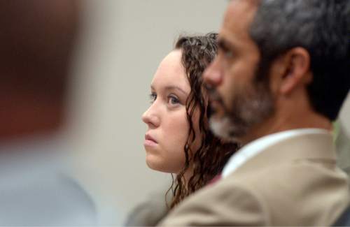 Al Hartmann  |  The Salt Lake Tribune
Meagan Grunwald listens to the prosecutor give closing arguments to the jury Friday, May 8, in her trial in Provo. Her defense lawyer, Rhome Zabriskie, at right. Grunwald is charged as an accomplice in a shooting spree that killed one police officer and wounded another on Jan. 30, 2014.