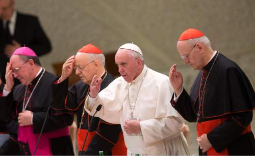 Pope Francis, second from right, delivers his blessing during a meeting marking the 50th anniversary of the creation of the Synod of Bishops, in the Paul VI hall at the Vatican, Saturday, Oct. 17, 2015. (AP Photo/Alessandra Tarantino)