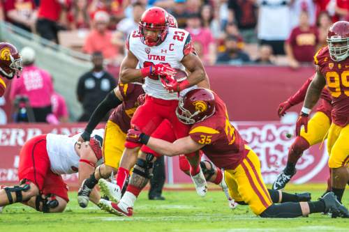 Chris Detrick  |  The Salt Lake Tribune
Utah Utes running back Devontae Booker (23) is tackled by USC Trojans linebacker Cameron Smith (35) during the game at the Los Angeles Memorial Coliseum Saturday October 24, 2015.