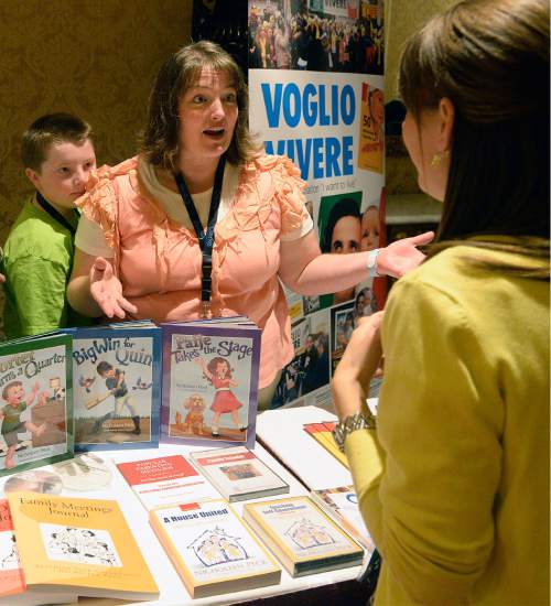 Al Hartmann  |  The Salt Lake Tribune
Nicholeen Peck, President of Worldwide Organization for Women (WOW) talks to a conference attendee during the second day of the World Congress of Families at the Grand America in Salt Lake City Wednesday Oct. 28. Her son Porter listens in.  She is an author of children's books too.  Her organization Teaching Self Government, (TSG) endorses good open family communication and offers books and videos on parenting and family support.