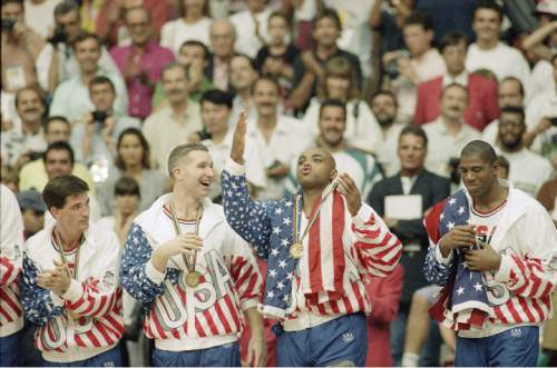 Tribune file photo

From left the USA's John Stockton, Chris Mullin, and Charles Barkley rejoice with their gold medals after beating Croatia, 117-85 in Olympics basketball in Barcelona Saturday, Aug. 8, 1992. The USA beat Croatia 117-85 to win the gold medal.