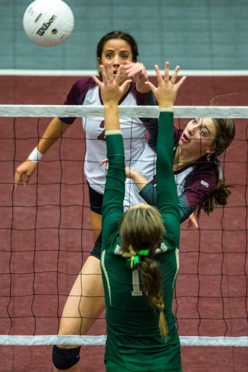 Chris Detrick  |  The Salt Lake Tribune
Morgan's Anna Cox (19) spikes the ball past Snow Canyon's Samantha Johnston (11) during the 3A championship match at the UCCU Center Thursday October 29, 2015.