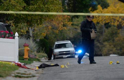 Al Hartmann  |  The Salt Lake Tribune
Scene of early morning double shooting-homicide Thursday Oct. 29 between a homeowner and assailant in Millcreek area of Salt Lake County.  Unified Police Dept. investigate the crime scene where the bodies fell.