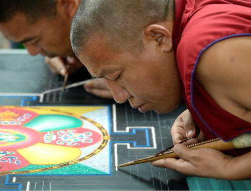 Al Hartmann  |  The Salt Lake Tribune
Buddhist monks from the Drepung Loseling Monastery create an intricate Mandala sand painting one grain of sand at a time at the Parliament of the World's Religions inside the Salt Palace Convention Center on Friday. It takes monks 3-5 days to complete a Mandala. An estimated 9,500 people from 50 religions will attend the event which runs through Monday.