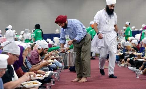 Al Hartmann  |  The Salt Lake Tribune
Several thousand attending the Parliament of the World's Religions wearing head covering sit together as equals on the floor of the Salt Palace Convention Center Friday, Oct. 16 and served food by members of the Sikh religious community at a traditional Langar.  Langar is a 500-year-old Sikh religion tradition where vegetarian food is served to all for free, regardless of religion or class.  Langar expresses the ideals of community, sharing and oneness of mankind.
