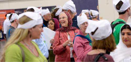 Al Hartmann  |  The Salt Lake Tribune
Participants at theParliament of the World's Religions talk and wear obligatory head coverings while waiting to be seated and served food at a traditional Langar.  Langar is a 500-year-old Sikh religion tradition where vegetarian food is served to all for free, regardless of religion or class.  Langar expresses the ideals of community, sharing and oneness of mankind. Several thousand sat together as equals on the floor of the Salt Palace Convention Center Friday, Oct. 16 and were served by dozens of Sikh volunteers.