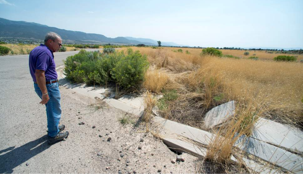 Rick Egan  |  The Salt Lake Tribune

Bill Lund, senior scientist for the Utah Geological survey, talks about the dangers of the falling water table, as he points out a fissure that stopped a subdivision from being built near Enoch, Thursday, August 20, 2015.