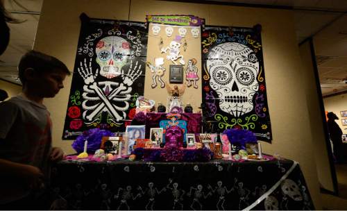 Francisco Kjolseth | The Salt Lake Tribune
People gather for the 12th annual Day of the Dead celebration and altar exhibition at the Utah Cultural Celebration Center in West Valley City on Sunday, Nov. 1, 2015. Una Mano Amiga constructed a central altar, surrounded by many community altars, and Dia de Los Muertos themed vignettes, creating a colorful, creative, and informative exhibition. Authentic Mexican food, music, dance, ceremonies, games, vendors, activities, and art stations were also part of the celebration.