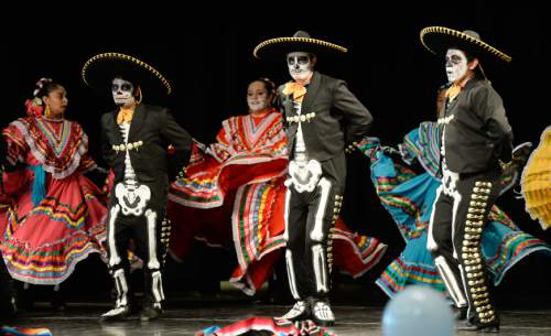 Francisco Kjolseth | The Salt Lake Tribune
Ballet Folklorico de las Americas performs for the 12th annual Day of the Dead at the Utah Cultural Celebration Center in West Valley City on Sunday, Nov. 1, 2015. Una Mano Amiga constructed a central altar, surrounded by many community altars and Dia de Los Muertos themed vignettes, creating a colorful, creative, and informative exhibition. Authentic Mexican food, music, dance, ceremonies, games, vendors, activities and art stations were also part of the celebration.