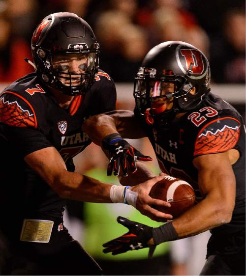 Trent Nelson  |  The Salt Lake Tribune
Utah Utes quarterback Travis Wilson (7) hands off to Utah Utes running back Devontae Booker (23) as the University of Utah hosts Oregon State, NCAA football at Rice-Eccles Stadium in Salt Lake City, Saturday October 31, 2015.