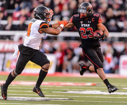 Trent Nelson  |  The Salt Lake Tribune
Utah Utes running back Devontae Booker (23) stiff-arms Oregon State Beavers safety Justin Strong (4) as the University of Utah hosts Oregon State, NCAA football at Rice-Eccles Stadium in Salt Lake City, Saturday October 31, 2015.