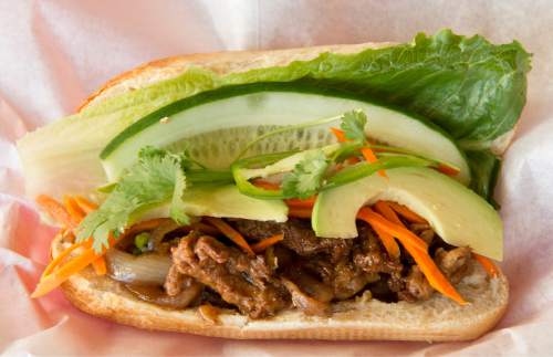 Rick Egan  |  The Salt Lake Tribune

Soy chicken banh mi: stir-fried soy chicken with onion and garlic, cucumber, avocado, cilantro, pickled daikon and carrots, jalapeño and house special soy sauce, at Little Saigon, a new Vietnamese restaurant in Sugar House.