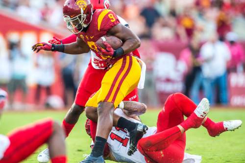 Chris Detrick  |  The Salt Lake Tribune
Utah Utes defensive back Tevin Carter (9) and Utah Utes defensive end Kylie Fitts (11) tackle USC Trojans wide receiver JuJu Smith-Schuster (9) during the game at the Los Angeles Memorial Coliseum Saturday October 24, 2015.