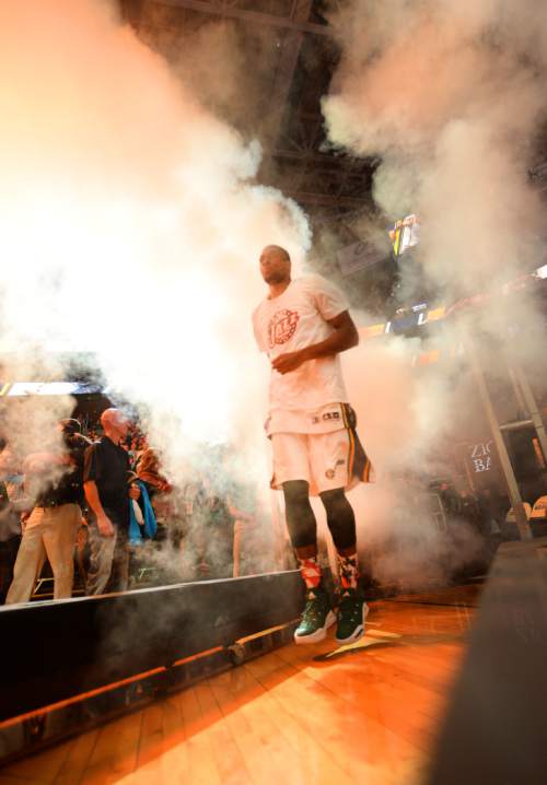 Steve Griffin  |  The Salt Lake Tribune

Utah Jazz forward Derrick Favors (15) walks through a smoke screen as he is introduced during the home opener for the Utah Jazz as they play the Portland Trailblazers NBA basketball game at Vivint Smart Home Arena in Salt Lake City, Wednesday, November 4, 2015.
