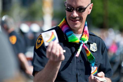 Lennie Mahler  |  The Salt Lake Tribune

Salt Lake City Police Chief Chris Burbank hands out stickers at the Pride Parade in downtown Salt Lake City, Sunday, June 7, 2015.