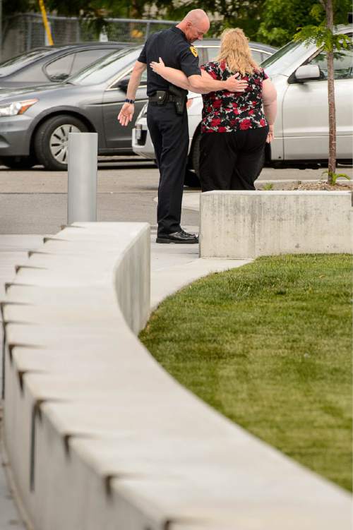 Trent Nelson  |  The Salt Lake Tribune
Former Salt Lake City Police Chief Chris Burbank embraces an unidentified woman after speaking to reporters about his departure in front of the Public Safety Building in Salt Lake City Thursday June 11, 2015.