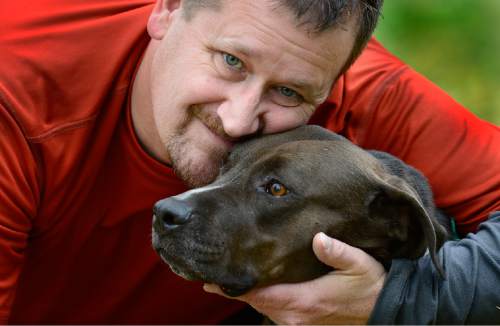 Scott Sommerdorf   |  The Salt Lake Tribune
Alex Gallivan with "Coco" a pit bull he is dog-sitting for neighbors, Saturday, October 24, 2015. Alex's own dog, "Chumley" recently passed away.