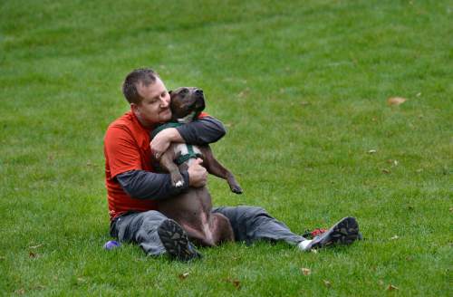 Scott Sommerdorf   |  The Salt Lake Tribune
Alex Gallivan with "Coco" a pit bull he is dog-sitting for neighbors, Saturday, October 24, 2015. Alex's own dog, "Chumley" recently passed away.