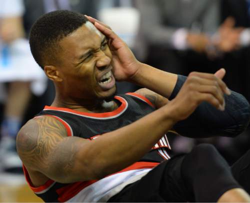 Steve Griffin  |  The Salt Lake Tribune

Portland Trail Blazers guard Damian Lillard (0) holds the side of his face after getting smacked during the Utah Jazz versus Portland Trailblazers NBA basketball game at Vivint Smart Home Arena in Salt Lake City, Wednesday, November 4, 2015.