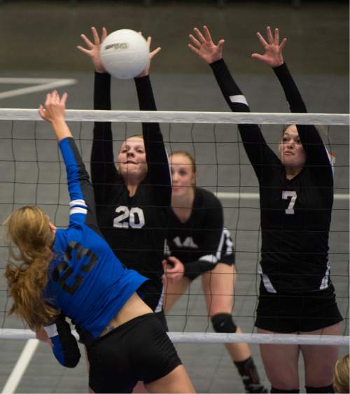 Rick Egan  |  The Salt Lake Tribune

Panguitch Bobcats Chesney Campbell  (23)hit the ball as Monticello Buckaroos Marci McDougall (20) and Averi Christiansen (7) defend, in prep 1A volleyball championship at Utah Valley University, Saturday, October 31, 2015.