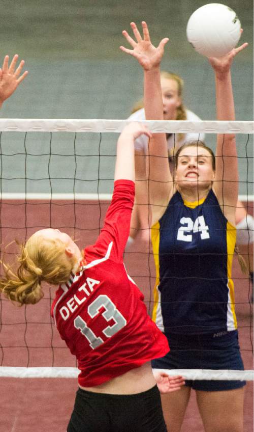 Rick Egan  |  The Salt Lake Tribune

Delta Rabbits Tatum Stanworth (13) hits the ball, as Enterprise Wolves Jessica Farnsworth (24) defends, in the prep 2A State Volleyball Championship game at Utah Valley University, Saturday, October 31, 2015.